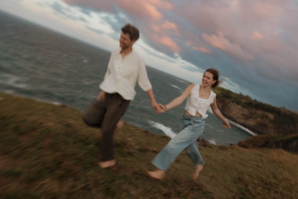 couple running on beach motion blur photography