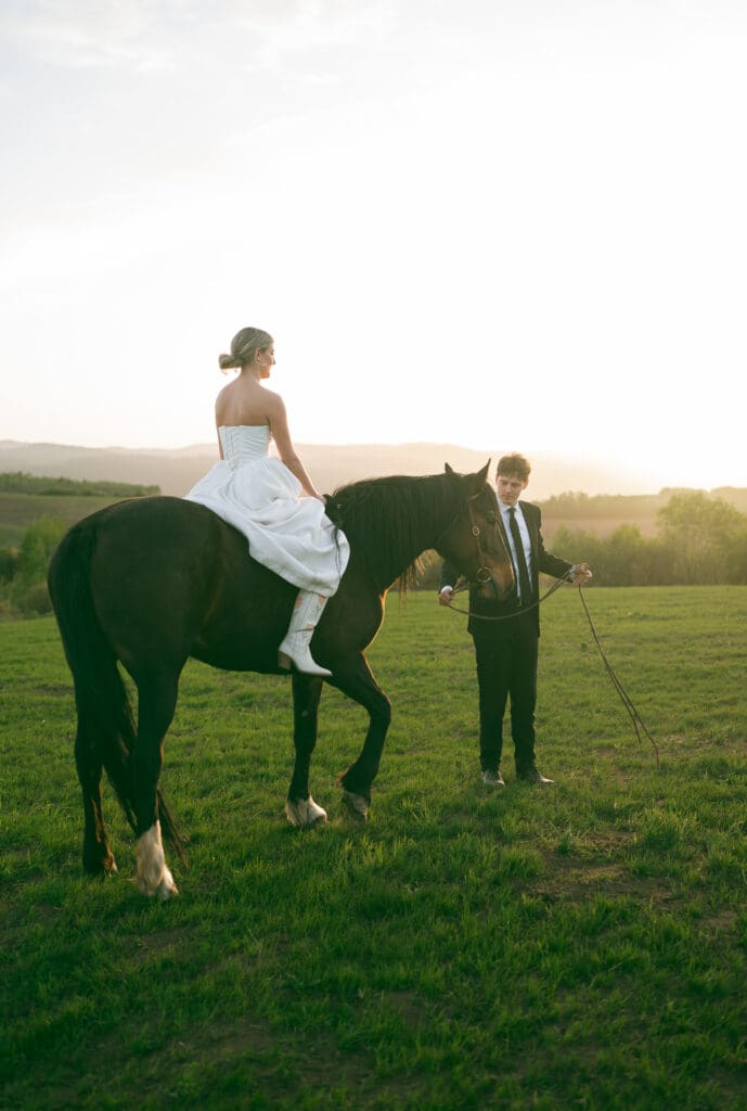 bride riding a horse at sunset with groom in jackson hole on wedding day