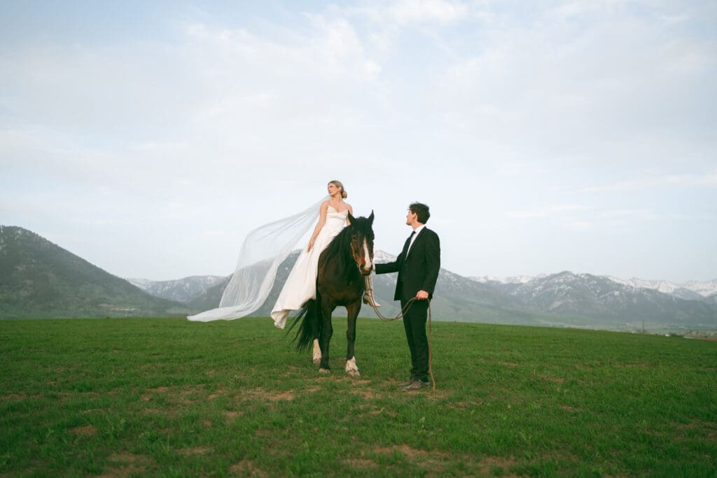 bride on horse with groom on wedding day in jackson hole