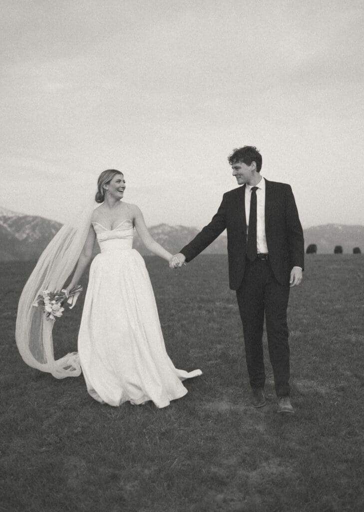 bride and groom on horse ranch walking