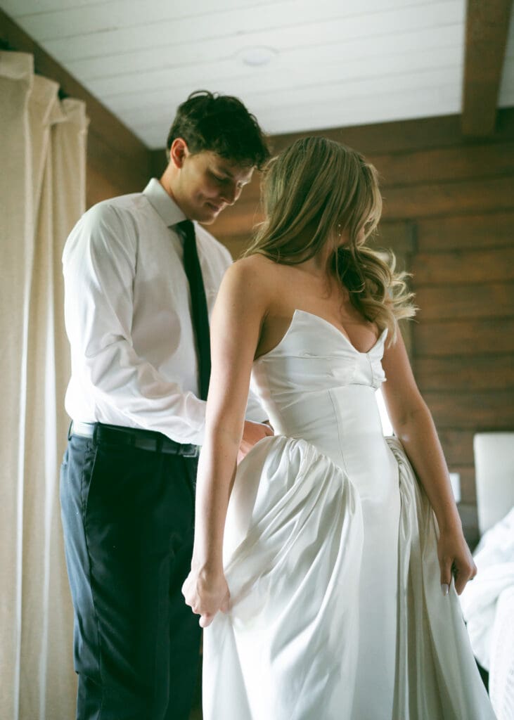 bride and groom getting ready together on wedding day in jackson hole wyoming