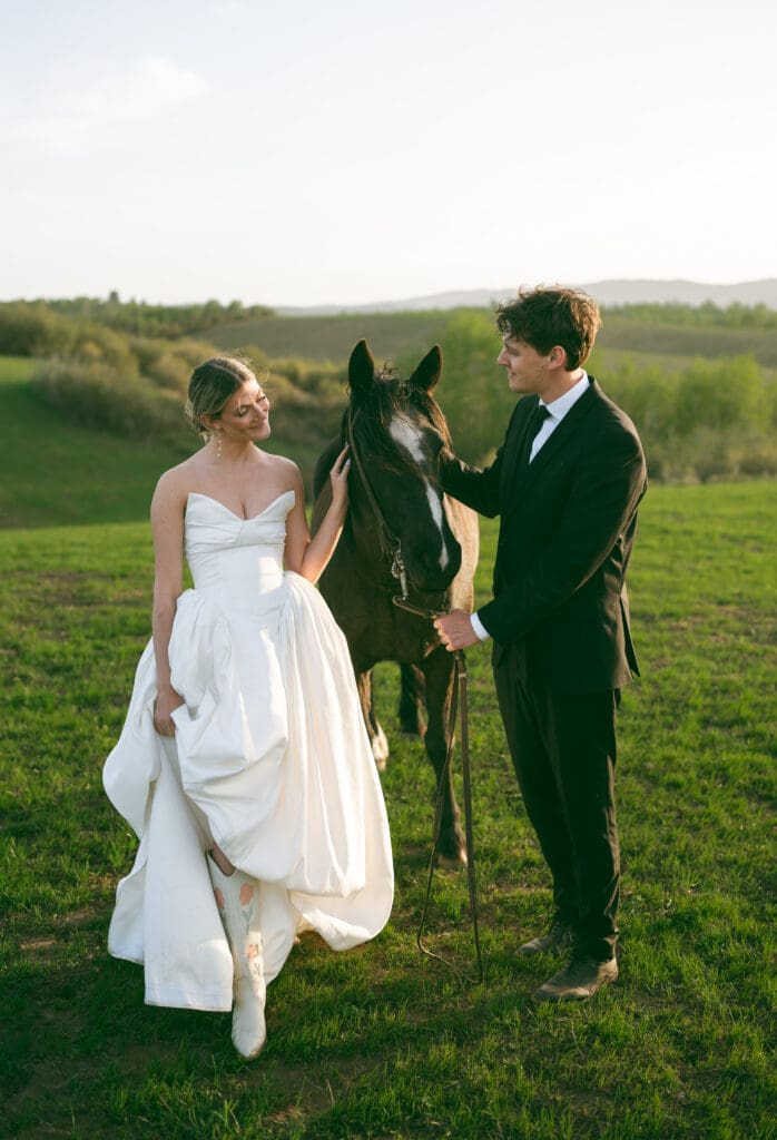 bride and groom petting a horse on wedding day in jackson hole